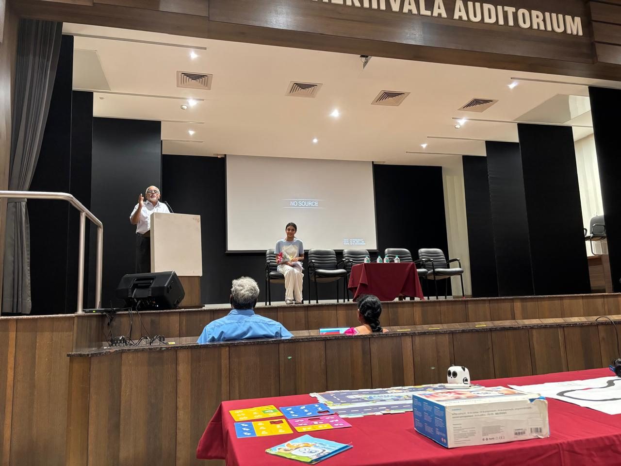 Wide view of a school auditorium presentation in India