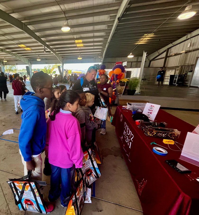Students engaging with a hands-on activity at the Charlotte Motor Speedway STEAM Expo